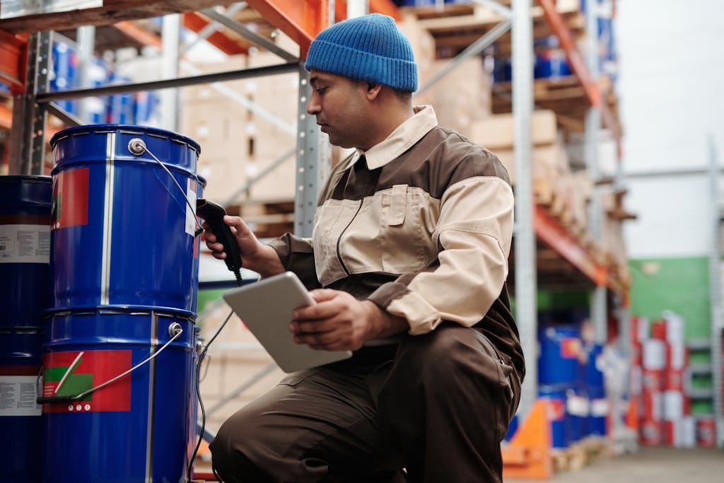 Warehouse employee scanning affordable, modern construction materials for homes using a tablet and scanner at the NFP storage facility.
